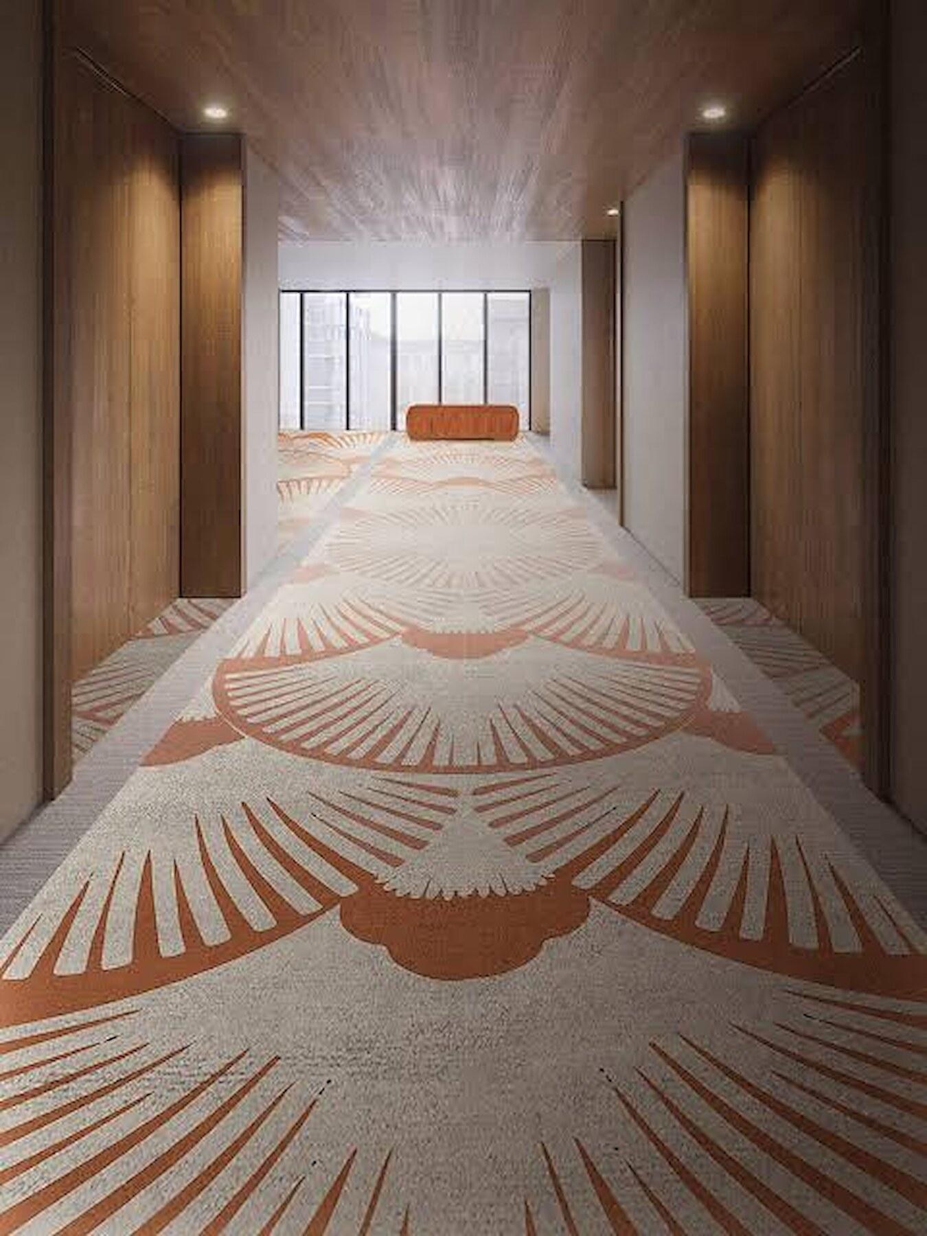 A hotel corridor with a custom fan-pattern runner in terracotta and cream